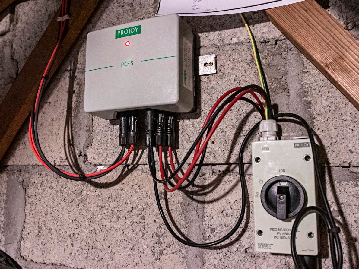 Certified technician inspecting solar panels on a rooftop